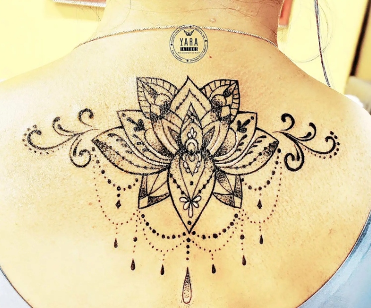 Close-up of a sacred geometry tattoo featuring precise geometric patterns and symmetrical linework, inked in black on skin, emphasizing balance, harmony, and intricate detail.